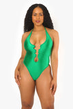 a woman in a green one piece bodysuit
