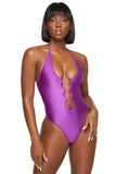 a woman in a purple one piece swimsuit