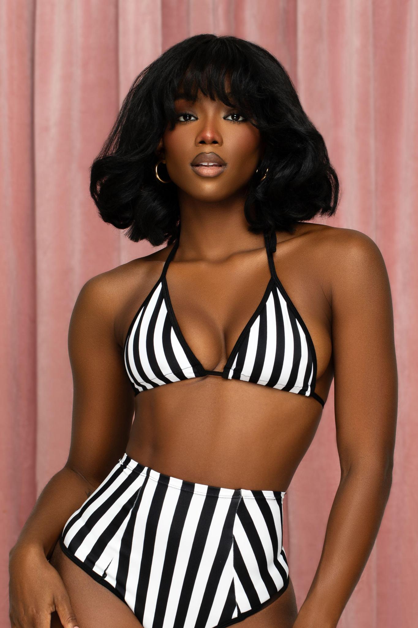 a woman in a black and white striped bikini